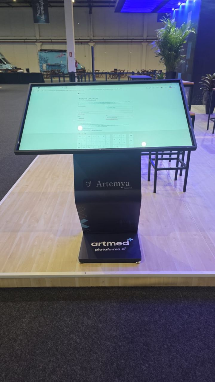 An Artemya kiosk on the Artmed stand at an event, with the sign-up screen open.